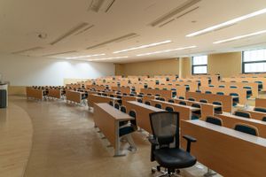 A lecture hall filled with empty desks