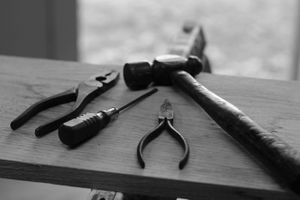 A black and white photo of tools on a workbench